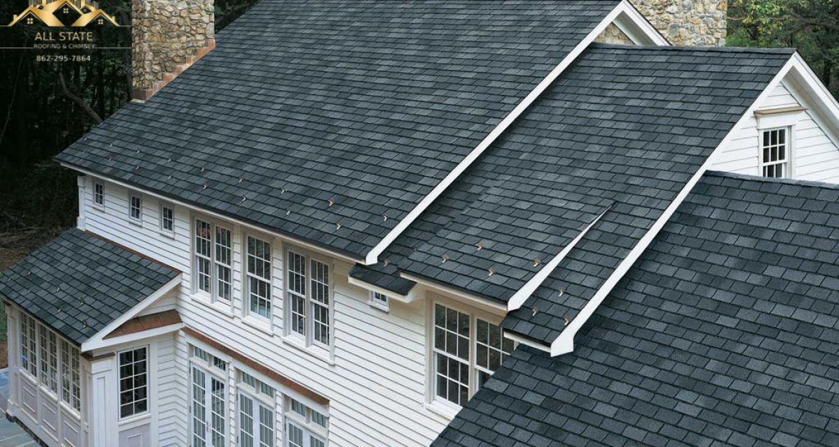professional-roof-replacement-gray-shingles-stone-chimneys.jpg